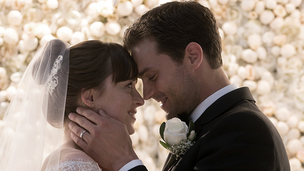 Dakota Johnson as Anastasia Steele and Jamie Dornan as Christian Grey at their wedding in FIFTY SHADES FREED.