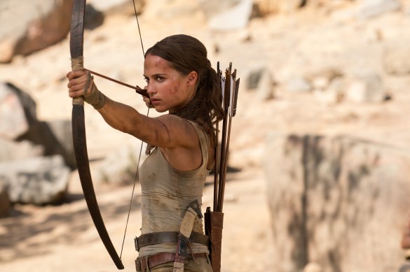 Alicia Vikander poised to fire an arrow in TOMB RAIDER.