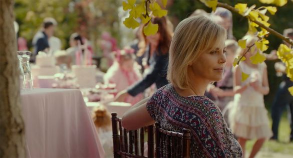 Charlize Theron stares off into the distance at a wedding in the film TULLY.