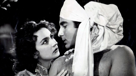 A black and white still of a woman looking at a man in an old Bollywood movie from the documentary Shalom Bollywood