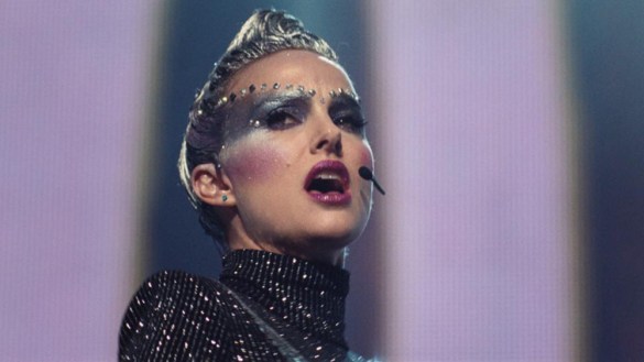 Natalie Portman singing in futuristic makeup in the film Vox Lux
