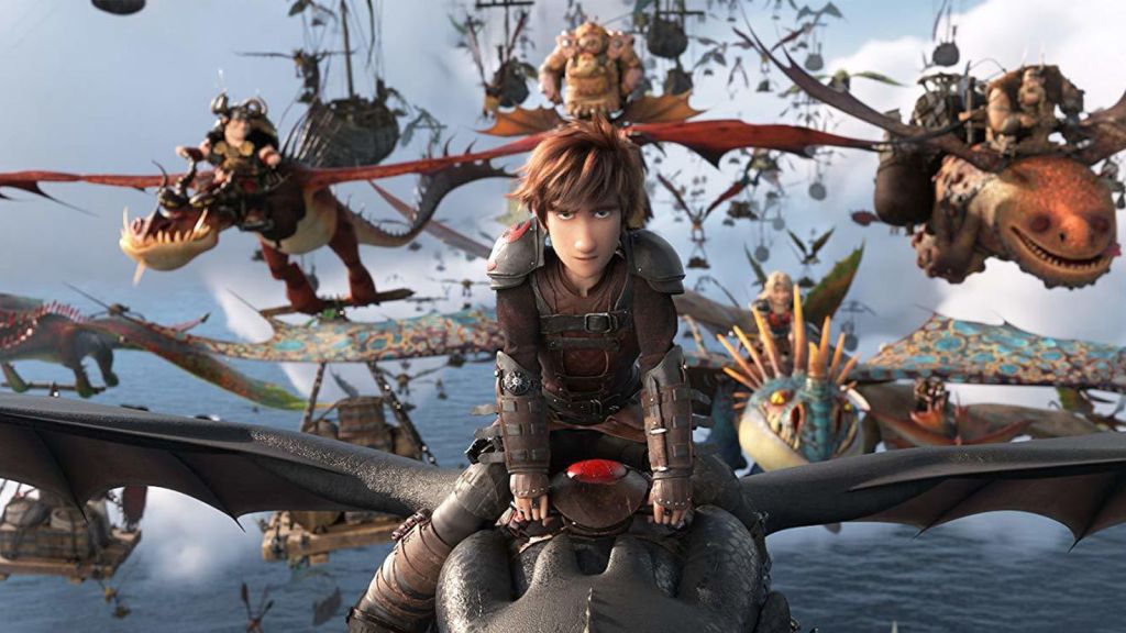 Hiccup (Jay Baruchel) rides a dragon with a fleet of dragons and riders behind him in the animated film How to Train Your Dragon: The Hidden World