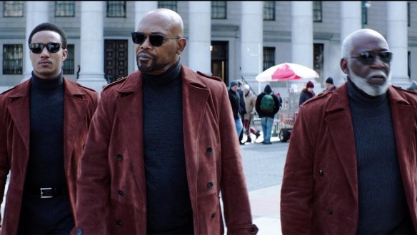 Jessie T. Usher, Samuel L. Jackson and Richard Roundtree dressed in sunglasses and red coats with black turtlenecks in the movie Shaft