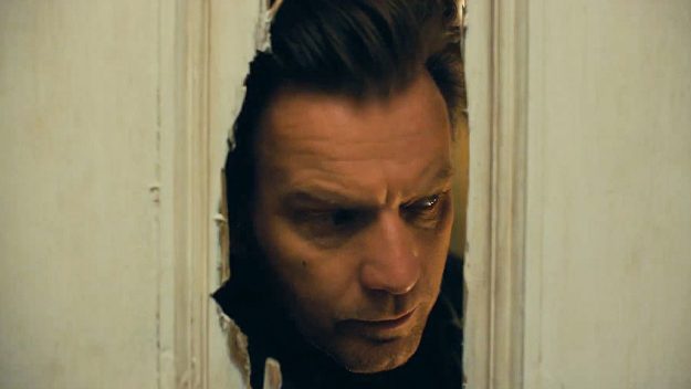 Ewan MacGregor peers through an axe hole in a door originally featured in The Shining, in the movie Doctor Sleep.