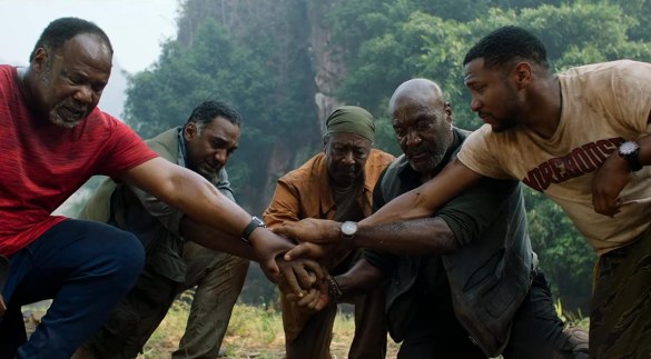 Delroy Lindo, Norm Lewis, Clarke Peters, Isiah Whitlock Jr., and Jonathan Majors in Da 5 Bloods crouch down and bring their hands together in the film Da 5 Bloods