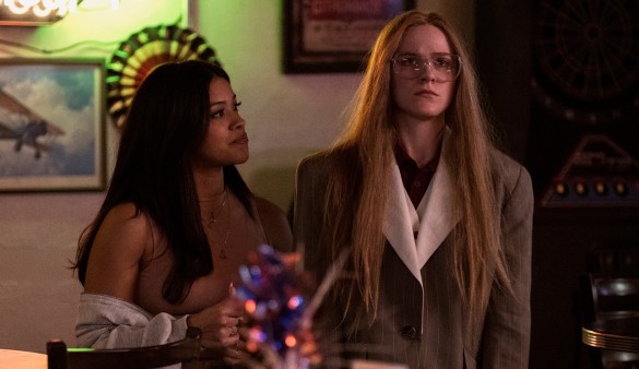 Gina Rodriguez looks at Evan Rachel Wood, who stares ahead blankly in the movie Kajillionaire