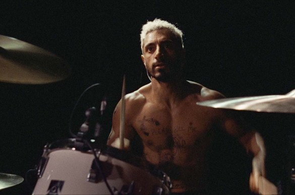 Riz Ahmed shirtless playing drums in the movie Sound of Metal